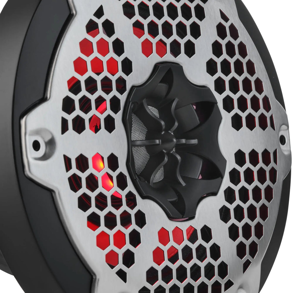 Close-up of a speaker's central driver and silver honeycomb grille with red lighting behind it