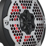 Close-up of a speaker's central driver and silver honeycomb grille with red lighting behind it