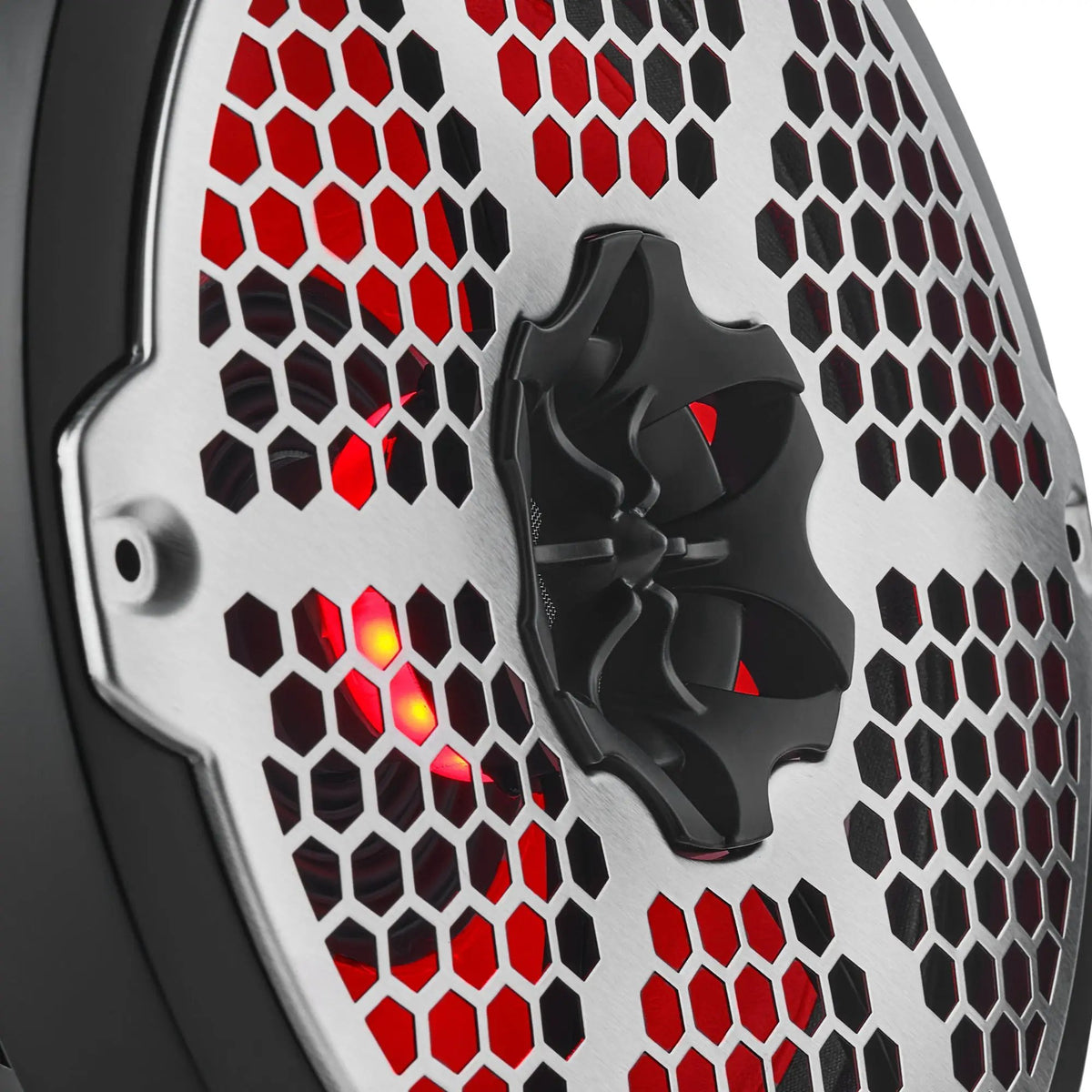 Close-up of a speaker's central tweeter, silver honeycomb grille and red lighting