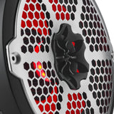 Close-up of a speaker's central tweeter, silver honeycomb grille and red lighting