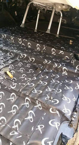 Close-up of GP-branded sound-deadening sheets fitted across a vehicle floor around mounting points