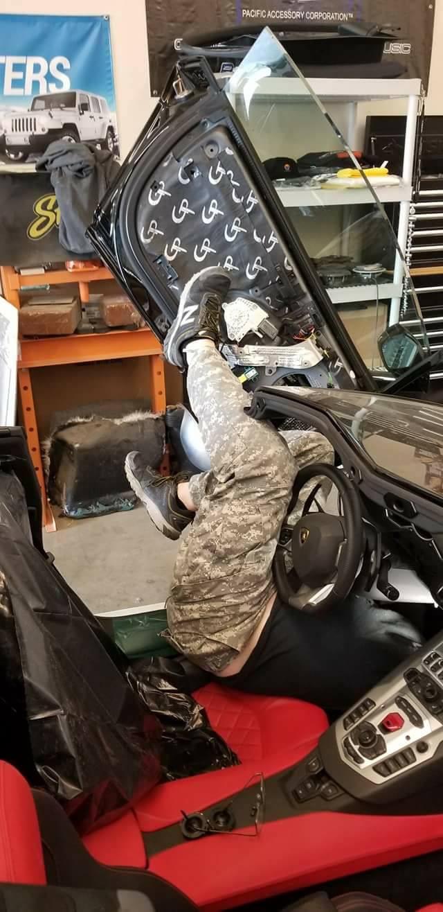 Vehicle door with its trim removed, showing GP-branded sound-deadening material installed on the inner panel