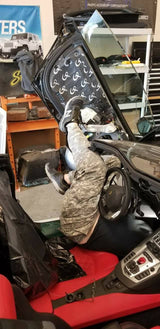 Vehicle door with its trim removed, showing GP-branded sound-deadening material installed on the inner panel