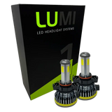 Two LUMI Stage 1 5202 LED headlight bulbs from Lumi are displayed in front of a black and green box labeled â€œLUMI LED Headlight Systemsâ€ on a white background, emphasizing their bright 6000K output and advanced 40-watt performance.