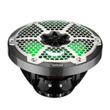 Low-angle view of a carbon-fiber-pattern DS18 speaker with green-lit honeycomb grille