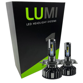 Two LUMI Stage 1 880 LED headlight bulbs from Lumi are displayed in front of a black and green box labeled â€œLUMI LED Headlight Systems.â€ With metallic bases and visible yellow LED strips, these 40 Watt, 6000K bulbs deliver brilliant illumination and are compatible with most vehicles due to their integrated LED CANBUS technology.