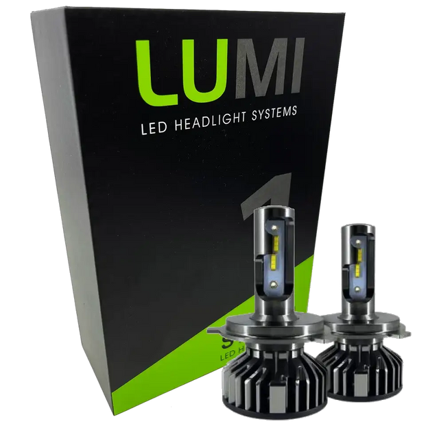Two LUMI Stage 1 880 LED headlight bulbs from Lumi are displayed in front of a black and green box labeled â€œLUMI LED Headlight Systems.â€ With metallic bases and visible yellow LED strips, these 40 Watt, 6000K bulbs deliver brilliant illumination and are compatible with most vehicles due to their integrated LED CANBUS technology.