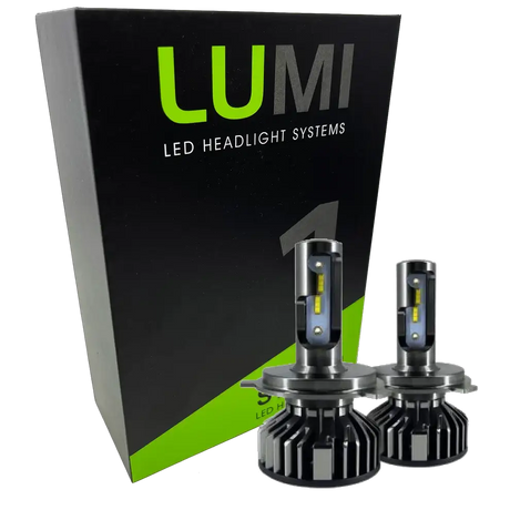 Two 40 Watt LUMI Stage 1 9007 LED Headlight Bulbs by Lumi are positioned in front of a black and green LUMI LED Headlight Systems box. The bulbs feature a metallic finish with prominent cooling fins at their bases and deliver brilliant 6000K illumination.