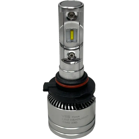 A silver LUMI Stage 2 9005 LED headlight bulb from Lumi, featuring a black and red base, finned heat sink, and a visible diode in the center marked â€˜V6S Focus LED Headlight EMC 23D.â€™ This model utilizes high-performance CSP chips to provide a crisp 6000K color temperature for enhanced visibility.