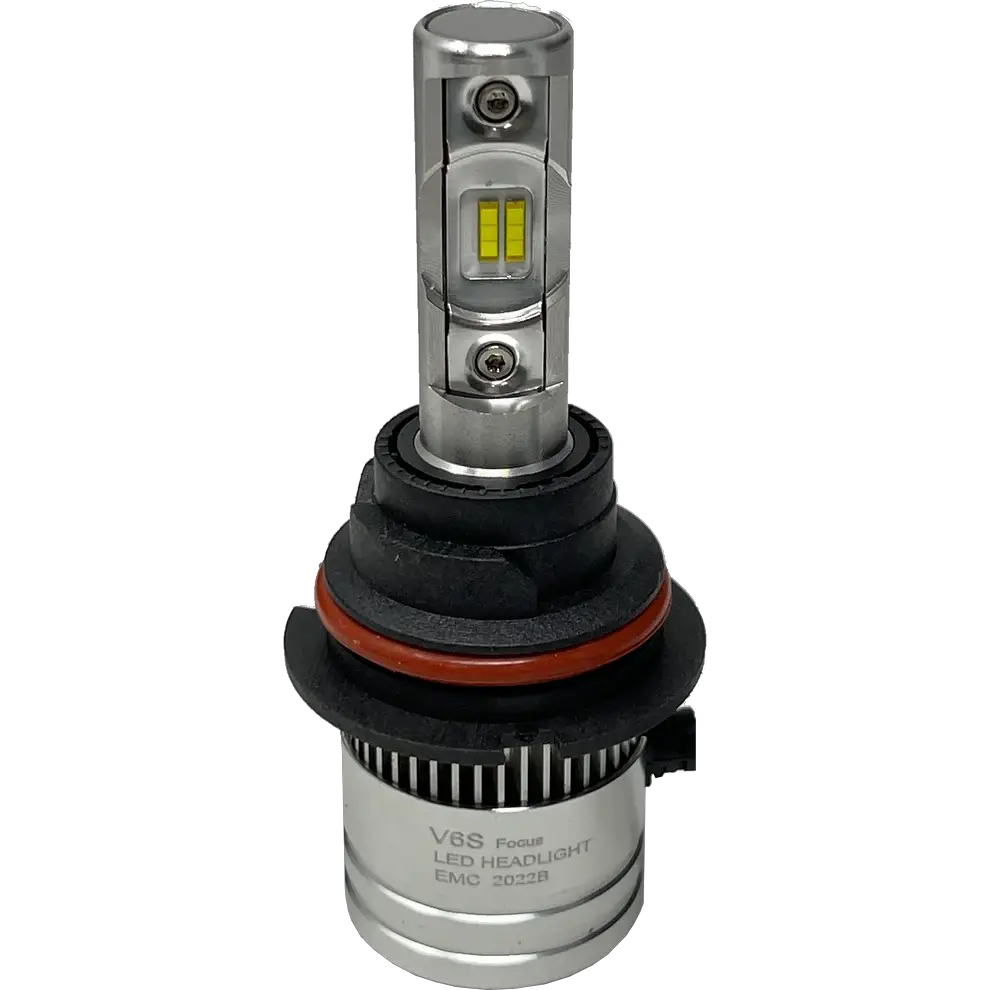 A silver LUMI Stage 2 9006 LED headlight bulb by Lumi, featuring visible yellow CSP chips, black and red rubber rings, and a cylindrical base labeled EMC 2022B, is displayed on a plain white backgroundâ€”ideal for those seeking modern LED headlights with a crisp 6000K output.