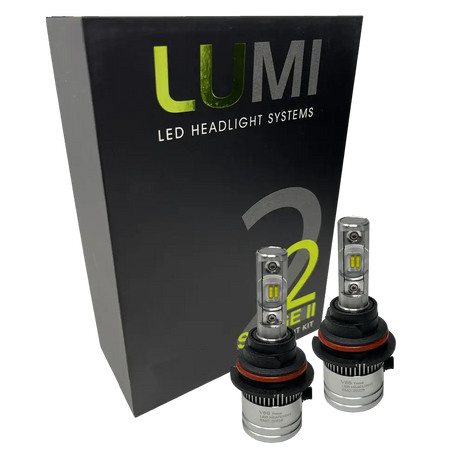 Two LUMI Stage 2 9006 LED Headlight Bulbs by Lumi, featuring advanced CSP chips and metallic bases with visible LED elements, are displayed in front of a black box labeled â€œLUMI LED Headlight Systems 2 Series II.â€ These bulbs deliver a crisp 6000K white light.