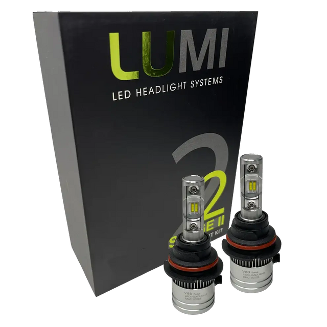 Two LUMI Stage 2 9006 LED Headlight Bulbs by Lumi, featuring advanced CSP chips and metallic bases with visible LED elements, are displayed in front of a black box labeled â€œLUMI LED Headlight Systems 2 Series II.â€ These bulbs deliver a crisp 6000K white light.