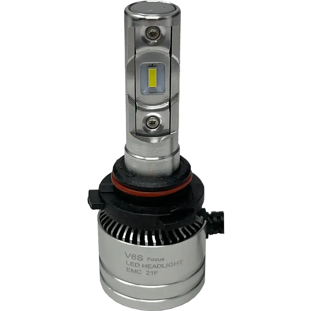 Introducing the LUMI Stage 2 9007 LED Headlight Bulbs by Lumi: Featuring a silver design with integrated cooling fins, a black and red gasket at the base, and visible CSP chips on the front for improved brightness. The bulbs include a black connector attached at the bottom, and â€œV6S Focus LED HEADLIGHT EMC 21Fâ€ printed on the base. These Lumi headlights emit a crisp 6000K white light, delivering superior visibility for nighttime driving.