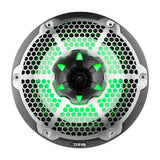 Front view of a DS18 speaker with a silver honeycomb grille, carbon-fiber-patterned trim and green illumination.