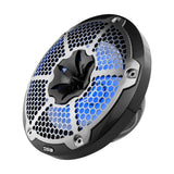 Angled view of a DS18 speaker with a silver honeycomb grille, carbon-fiber-patterned trim and blue illumination.