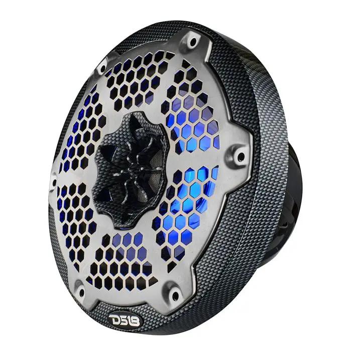 Angled front view of a carbon-fiber-patterned DS18 speaker with a silver honeycomb grille and blue lighting
