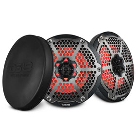 Two DS18 speakers with carbon-fiber-patterned rims, silver honeycomb grilles and red lighting, beside a black protective cover.
