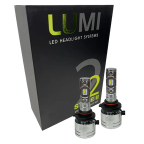 Two LUMI Stage 2 H10 LED Headlight Bulbs from Lumi, each delivering a bright 6000LM output with high-quality CSP chips, are displayed in front of a black Lumi LED Headlight Systems Stage 2 box against a white background.