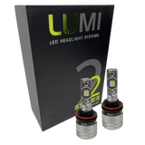 Two metallic Lumi Stage 2 H11 LED Headlight Bulbs, equipped with advanced CSP chips and delivering a crisp 6000K color temperature, are displayed in front of a black Lumi LED Headlight Systems box featuring â€œStage IIâ€ and â€œ2â€ branding.