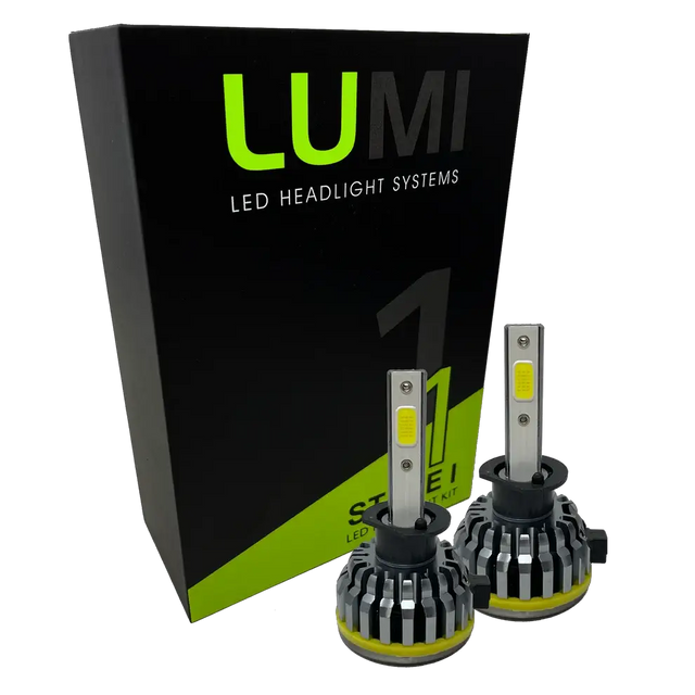 Two LUMI Stage 1 H1 LED Headlight Bulbs are displayed in front of a black and green Lumi box labeled â€œStage 1 LED Headlight Kit,â€ featuring a powerful 40-watt output and a crisp 6000K color temperature for superior visibility.