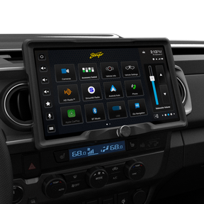 Angled view of a Stinger touchscreen installed between round dashboard vents, showing the main app menu