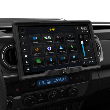 Angled view of a Stinger touchscreen installed between round dashboard vents, showing the main app menu