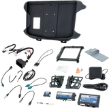 Radio installation kit laid out with molded dash panel, brackets, wiring harnesses, interfaces and mounting hardware