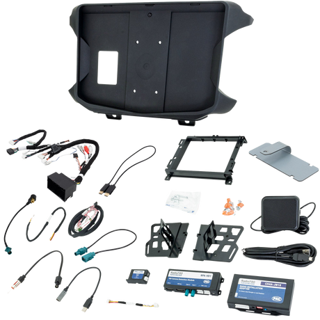 Radio installation kit laid out with molded dash panel, brackets, wiring harnesses, interfaces and mounting hardware