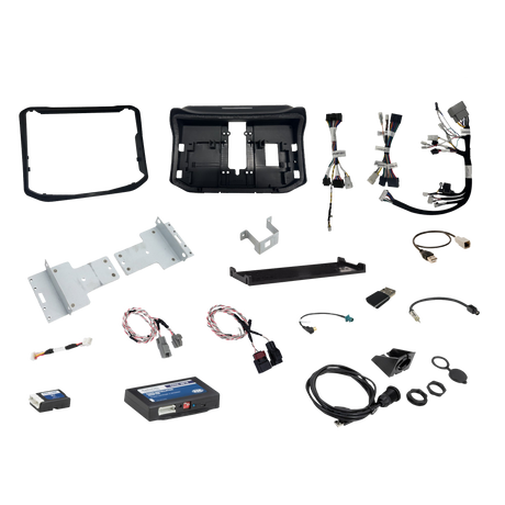 Radio installation components laid out with dashboard panels, mounting brackets, interface modules, wiring harnesses and adapter leads