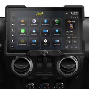 Wide Stinger touchscreen installed above round dashboard vents, showing source icons and a radio panel