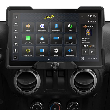 Wide Stinger touchscreen installed above round dashboard vents, showing source icons and a radio panel
