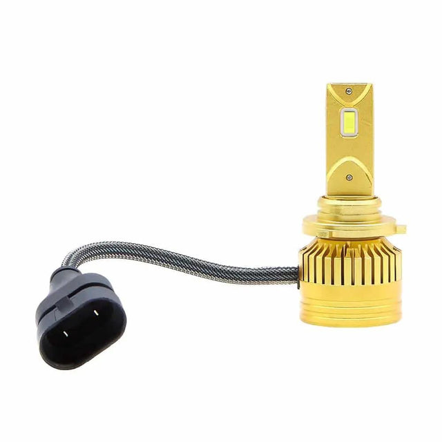 Gold-colored LED bulb with a tabbed mounting collar, finned base and braided lead to a black two-pin plug