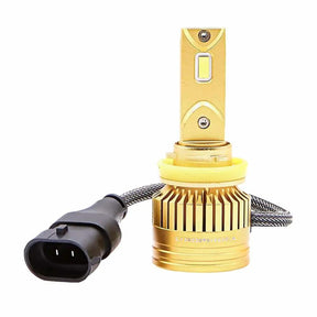 Gold-colored LED bulb with a finned round base, yellow collar and braided lead to a black two-pin plug