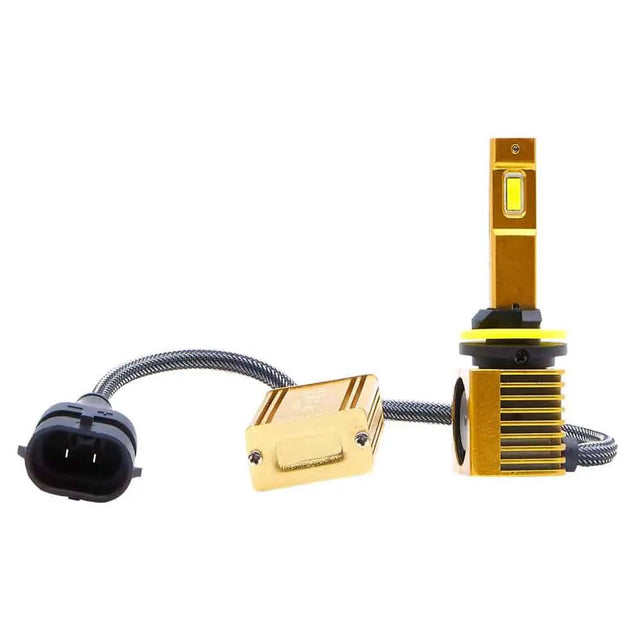 Gold-colored LED bulb with a black collar and yellow ring, square finned base and inline module on a braided cable