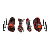 Speaker wiring leads with orange and white connectors laid out beside mounting screws