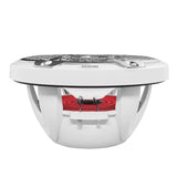 Side profile of a white speaker showing its open basket, red suspension and terminals beneath the silver grille.