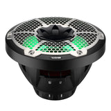 Black DS18 speaker with a silver honeycomb grille and green illumination, low angled view