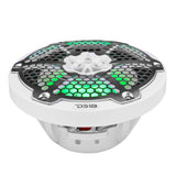 Low angled view of a white DS18 speaker showing green lighting behind its silver honeycomb grille and the basket below.