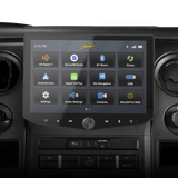 Stinger touchscreen installed in a vehicle dashboard, displaying its main app menu above the factory controls