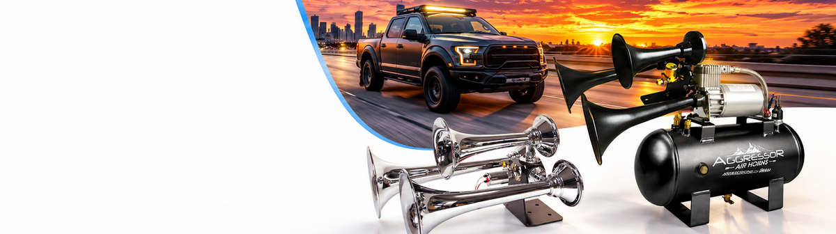 Aggressor black horn and compressor kit with chrome air horns and a pickup at sunset.