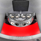 Close-up of subwoofer terminals marked 2x4 Ohms, with polarity symbols and connection screws
