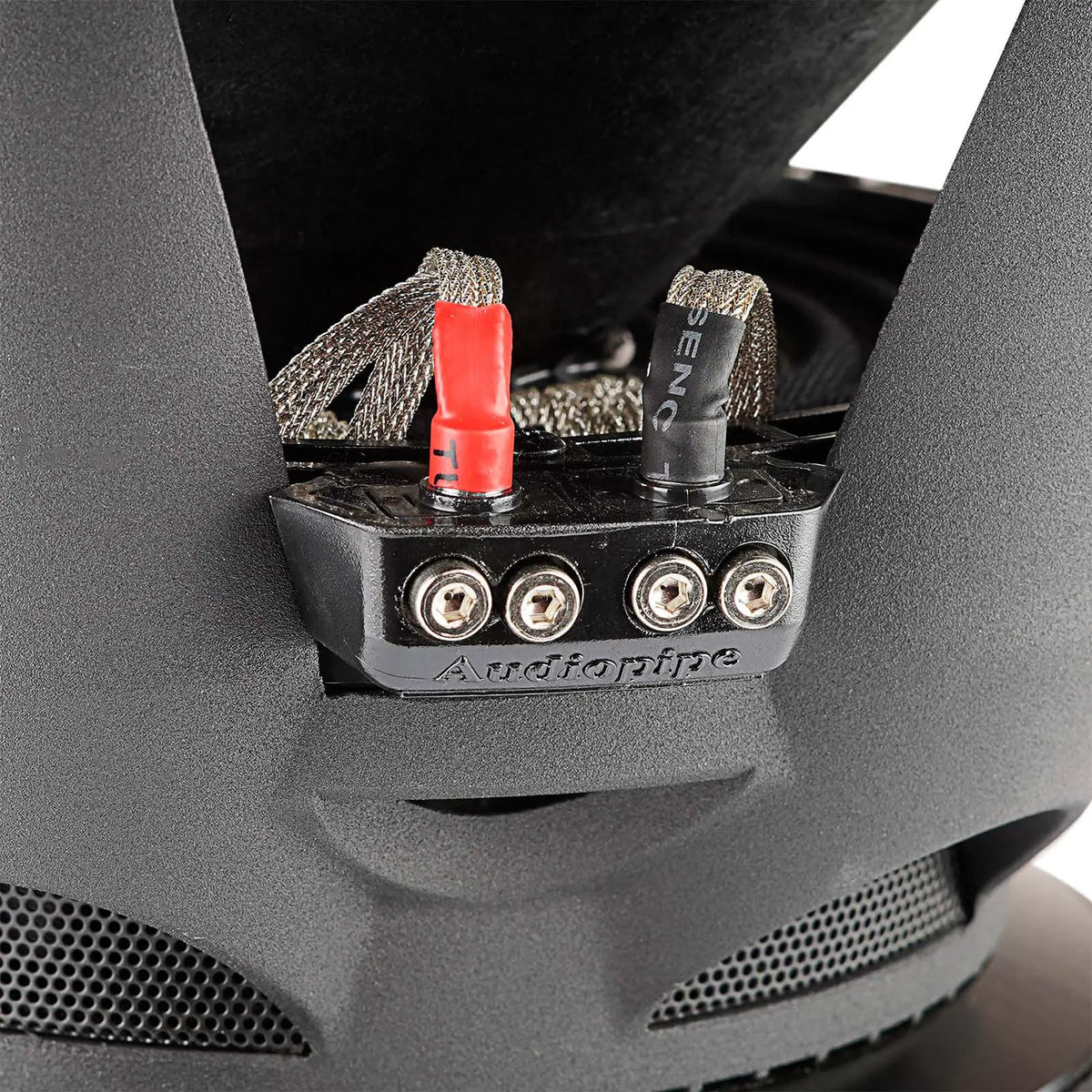 Audiopipe subwoofer terminal block with four screw connections, red and black markings and braided leads