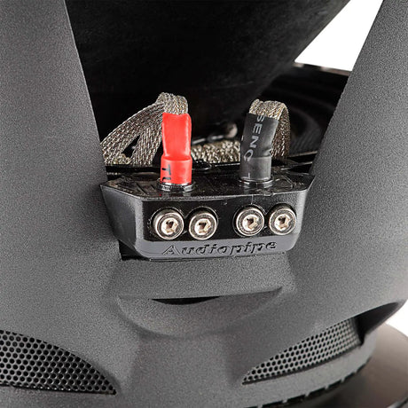 Audiopipe subwoofer terminal block with four screw connections, red and black markings and braided leads