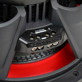 Close-up of a four-terminal subwoofer block marked 2x4 ohms, with positive and negative connection markings