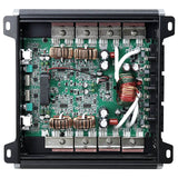 Open amplifier chassis showing a green circuit board, copper coils and internal wiring