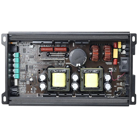 Open amplifier chassis showing two yellow transformers, copper coils, capacitors and a cooling fan