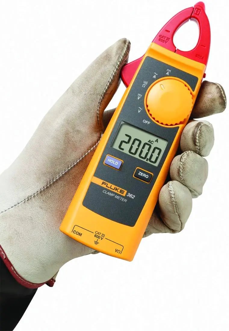 Gloved hand holding a yellow Fluke 362 clamp meter with red jaws and a display reading 200.0