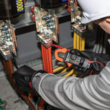 Technician using an orange-jawed Klein clamp meter and test probe at an electrical busbar assembly