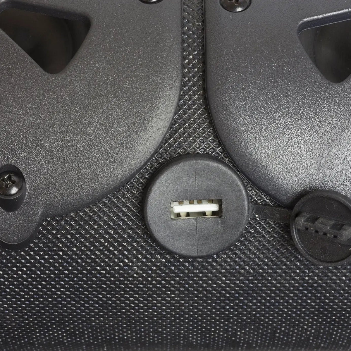 USB socket beneath an open rubber cover between two soundbar speakers