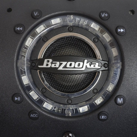 Close-up of a Bazooka soundbar speaker with an illuminated ring and volume, playback, mode, accessory and lighting buttons